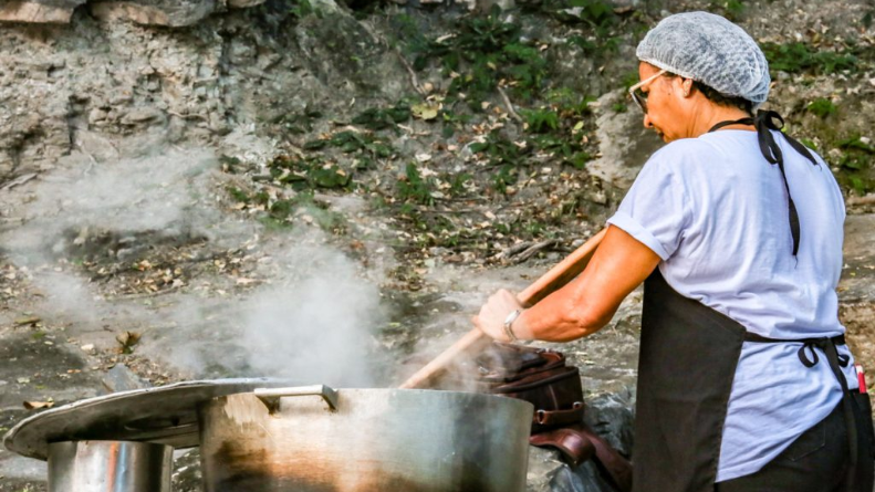 Cozinheira durante o preparo da comida regional servida no Quebra-torto. (Foto: Divulgação)